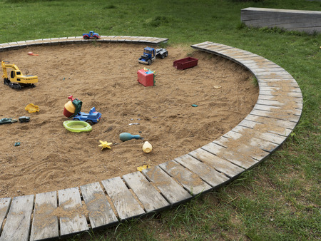Children's playground with a sandbox and toys. Relaxation park, leisure place for families and...
