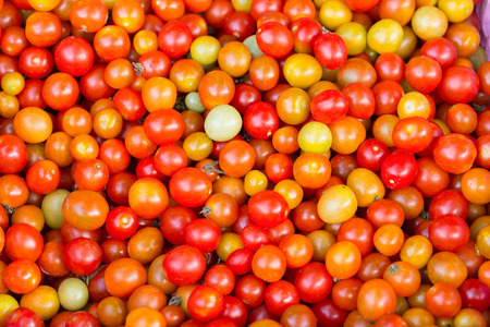 background with fresh red tomatoes in marketの写真素材