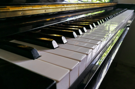 Piano keys close up using warm filter. Playing with lightの写真素材