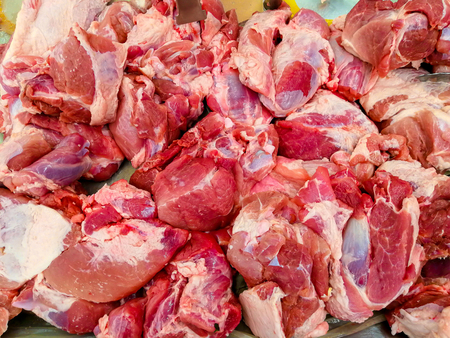 Fresh pieces of pork on the market counterの写真素材