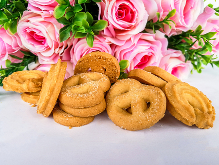 almond cookies and rose on woodenの写真素材