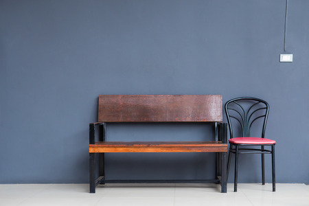 Old wooden bench stands against the wallの写真素材