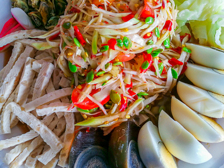 Papaya salad on top with salted eggの写真素材