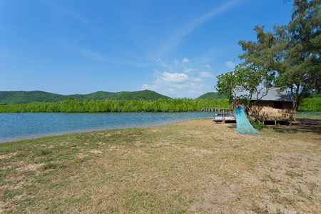 wooden house along the lush riversideの写真素材