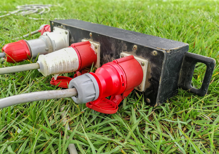 three five pin outside power plugs connected to a campsite water and electricity supply point