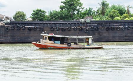 A tug boat middle of the riverの写真素材