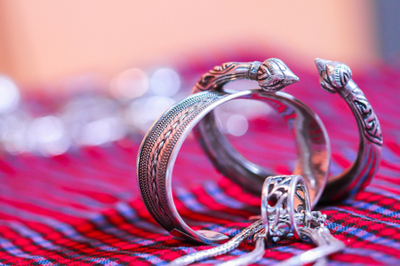 Vintage silver belt hung on female mannequins in Thailand craft market