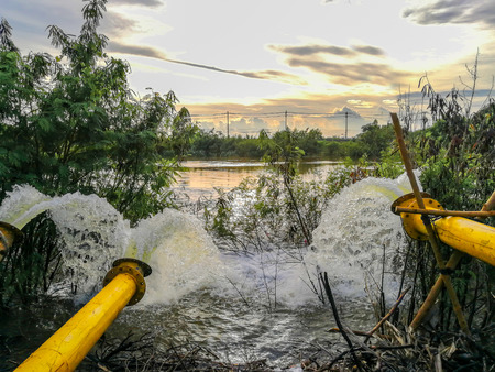 Waste water flow from water pipe into lakeの写真素材