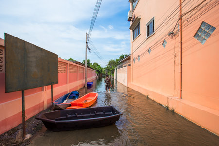 Thailand,october,15,2560,Roads or entrances to villages, in rural areas of Thailand, that are flooded by floods, make roads unavailableのeditorial素材