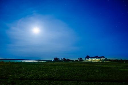 Beautiful night starry landscape. Stars reflected in the water at night. Astrophotography. Clear starry night sky. Slow shutter speed. The spectacular night sky. Scenic view at nighの写真素材
