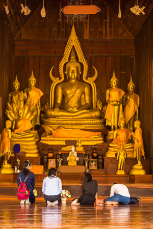 kalasin Thailand - march, 1, 2018,Buddhist tourist woman worshiping old Buddha image in ruined buddhist church in Kalasin Thailandのeditorial素材