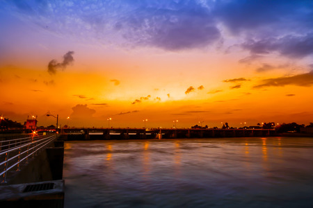 Sunset sky background. Dramatic gold sunset sky with evening sky clouds over the sea. Stunning sky clouds in the sunseの写真素材
