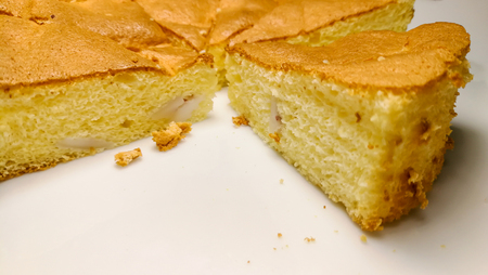 White bread cut into slices on a plate on white background