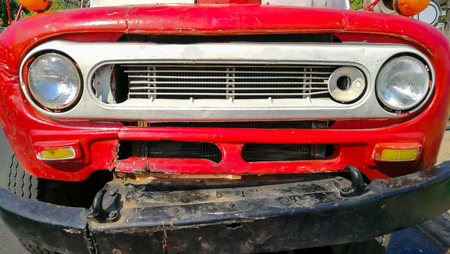 kalasin, thailand, April 11, 2018, the front of an old red car parked in rural Thailand