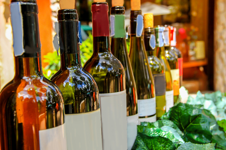 Row of dark colored wine bottlesの写真素材
