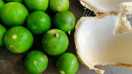 Green orange background. Close-up lime pile on table. Green ripe lime with glossy surface backdrop. Fresh summer wallpaper.の写真素材