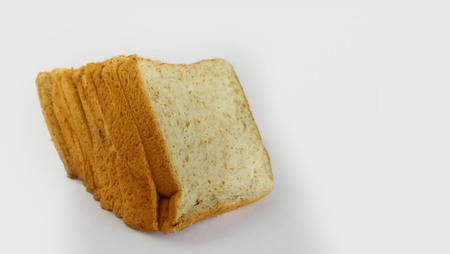 several slices of whole grain bread over a white surface