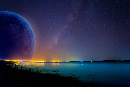 Milky Way and pink light at mountains. Night colorful landscape. Starry sky with hills at summer....