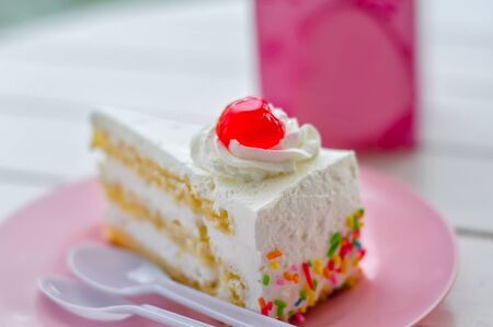 Crape cake slice and spoon on white plate on table wood background