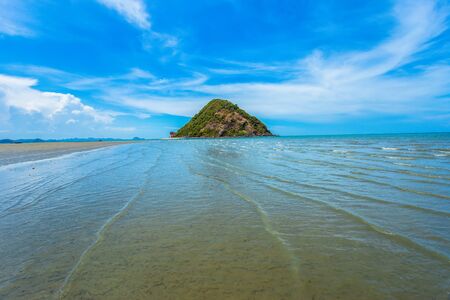 View of beautiful beach with clear blue water, golden sand, colorful boats and mountain on background. Summer landscape of Paleokastritsa on Corfu Island, Greece and Ionian Seaの写真素材
