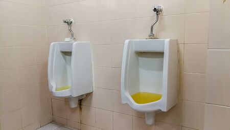 Dirty terrible toilet in a public toilet. Plating deteriorated from moisture and urine. Hue yellow urine in toilet, dirty floorの写真素材