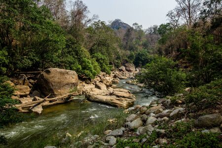 Close up of river stream flowing down over the grey stones. Stock footage. Fast and cold brook with...