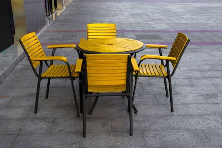 Yellow table and yellow bench on the cement floorの写真素材