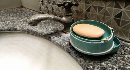Old faucets and soap for hand cleaning in rural bathroomsの写真素材