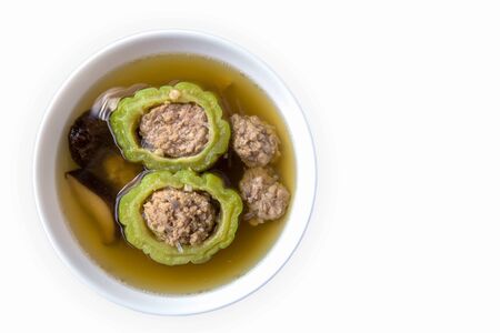 Bitter gourd soup with pork in a bowl on woodenの写真素材