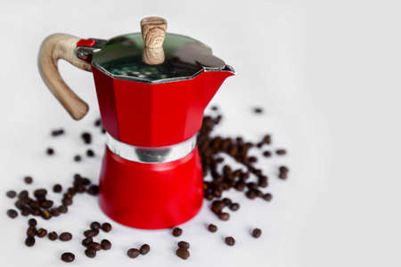 The kettle is used to boil fresh red coffee and coffee beans on a White backgroundの写真素材