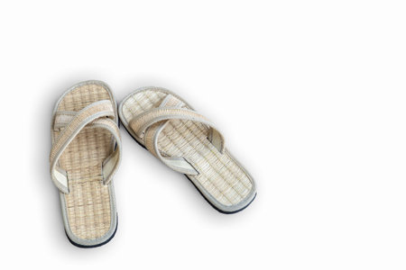 Close up old used wooden Japanese sandal isolated on white background. It is a form of traditional Japanese footwear that resemble both clogs and flip-flops.の写真素材