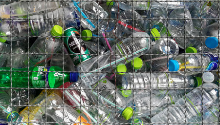 3,Mar,2018,lopburi thailand,Pile of empty water plastic bottle in mesh fence recycle bin. Plastic...