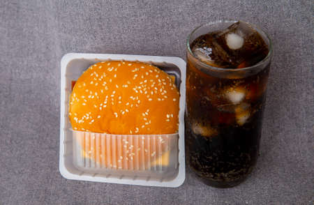 Homemade burger and cheese with fries and icy soft drinkの写真素材