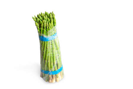 Bunch of fresh green asparagus isolated on white background. Freshly picked asparagus with water drops isolated on white background.の写真素材
