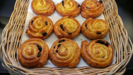 Bakery in brown wooden tray in bakery shop. Fresh bake pastry product. Sweet bread display on...