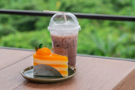 orange cake and late coffee cup on beautiful tableの写真素材