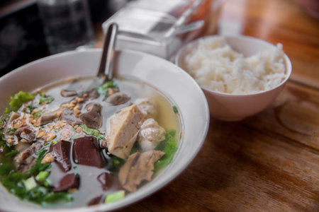boiled pork blood and entrails in soup with riceの写真素材