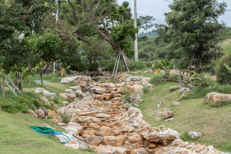 Tropical garden with rocks and stones for drainage in a public park in rural Thailand.の写真素材