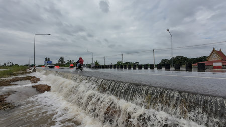 Rural roads in Thailand were flooded as storms swept through the country, causing rivers to overflow and inundate homes and roads.のeditorial素材