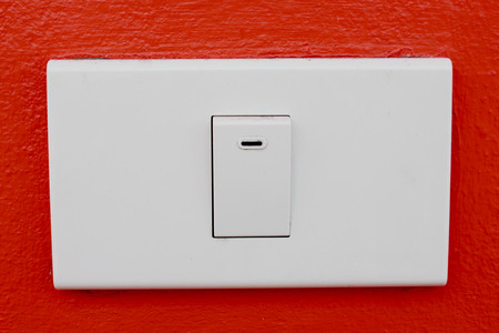 Wall switch on the red wallの写真素材