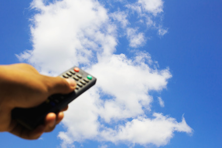 Hand using tv remote controlの写真素材