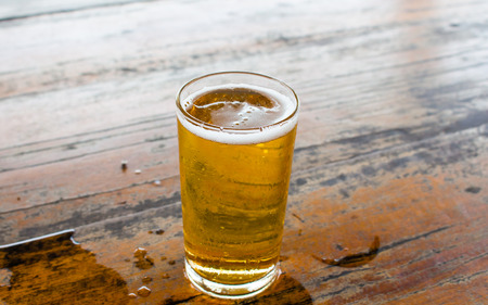 Glass beer on wood background