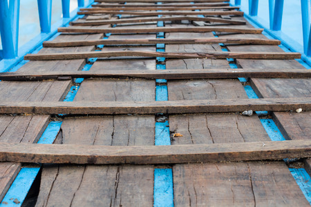 Wide angle wooden bridge with rusted joists in woodsの写真素材