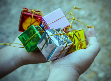 Hand hold gift box Merry Christmas vintage color toneの写真素材