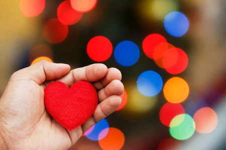 Valentines Day background with hand hold heartの写真素材