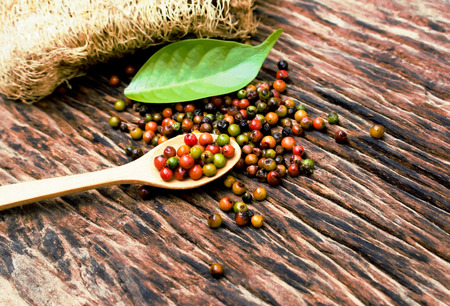 pepper on spoon wood background.の写真素材