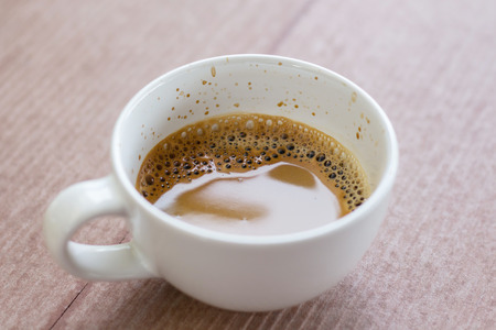 Hot espresso coffee on wood background, top view