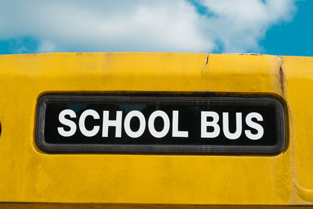 Yellow back of school bus with a signの写真素材