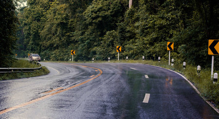 Cars running on road It was raining, the road is slippery.の写真素材