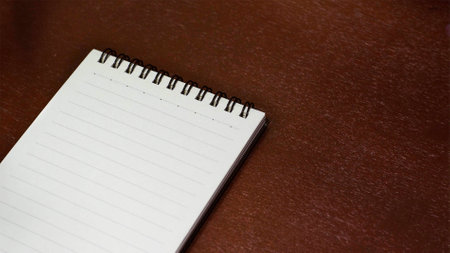 Notebook on a wooden tableの写真素材